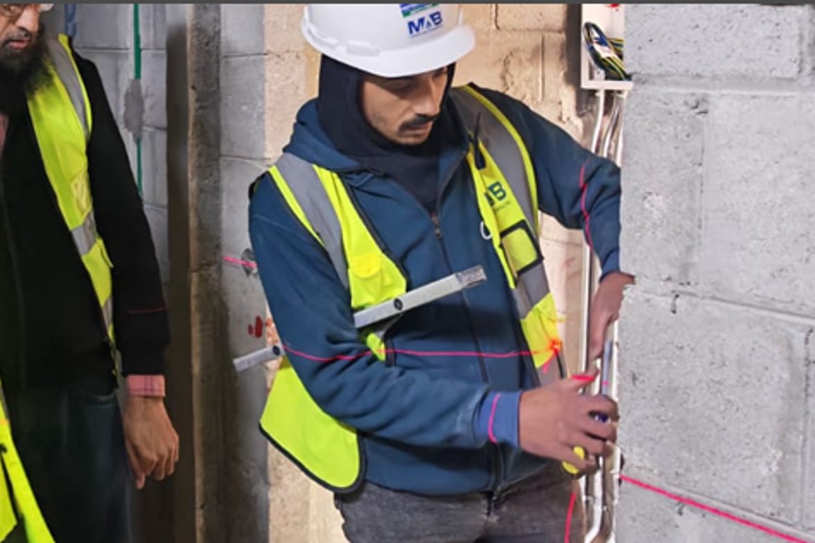 A MAB United engineer setting out services on site